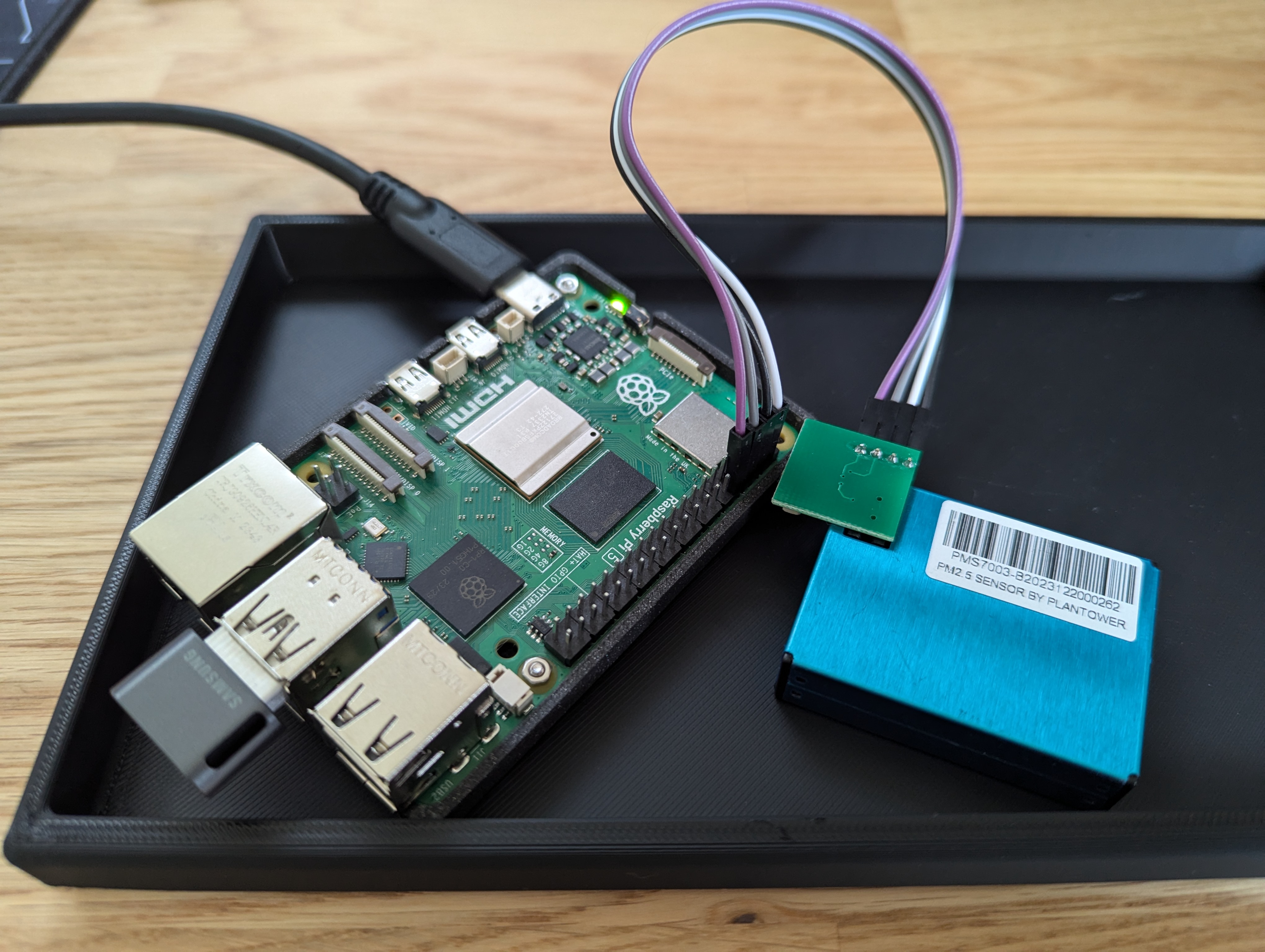 A photo of a raspberry pi and air sensor wired together